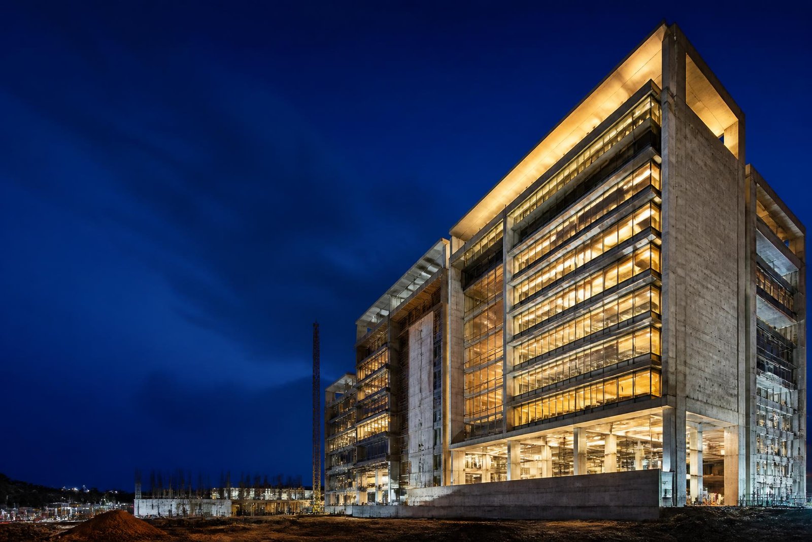 Large contemporary commercial building illuminated at blue hour